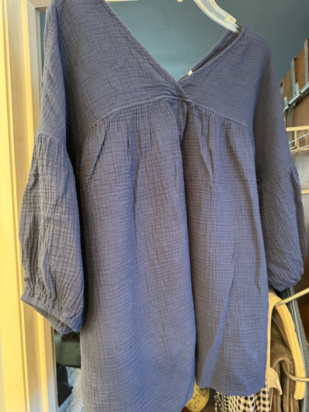 Navy blue gauze blouse w/ v-neck in front & back. Bell sleeves-elbow length.